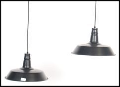 A pair of retro / vintage industrial style factory pendant of enamel metal in the UFO style. both in
