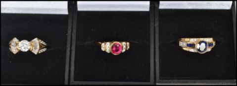 A group of three sterling gilt silver 925 dress rings, one having a central blue faceted stone,