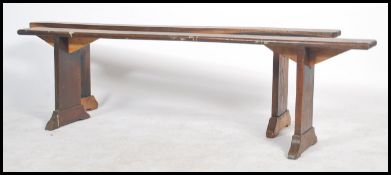 A near pair of 19th century French rustic pine refectory pig benches. Each with shaped single