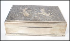 A vintage 20th century Thai sterling silver cigarette box having Niello decoration to id depicting