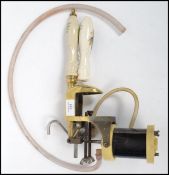 A vintage 20th century brass draught wine pump having changeable ceramic handles for white and red
