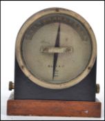 An early 20th century pre war 1915 W G and Co Pye electrical meter of dome form raised on a wooden