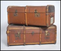 Two vintage 20th century canvas and wooden bound steamer luggage trunks having brass locks to front,