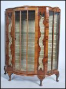 An early 20th century circa 1930's  Art Deco walnut bow front display cabinet, with two glazed doors