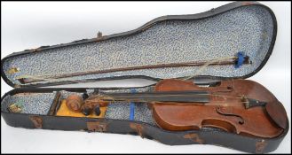 An early 20th century violin and bow ( unsigned or with paper label ) complete in the wooden