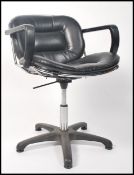 A retro 20th century wirework and black leather salon chair in the manner of Harry Bertoia having