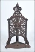 A 19th century Victorian cast iron umbrella stick stand being pierced decorated with scrolls and