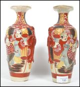 A pair of early 20th century Japanese Kutani ware vases each with hand finished detail depicting