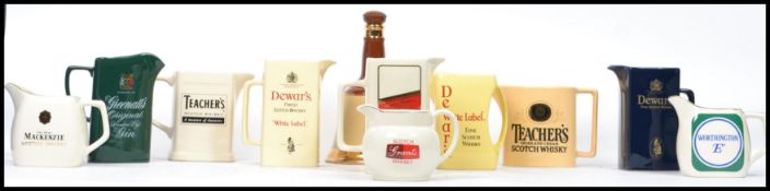 A good group of vintage 20th century advertising point of sale breweriania whiskey label jugs to