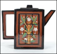 A Watcombe Porcelain ceramic teapot attributed to Christopher Dresser of square for having a painted