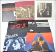 A collection of vintage long play LP vinyl record albums pertaining to The Police and U2 to