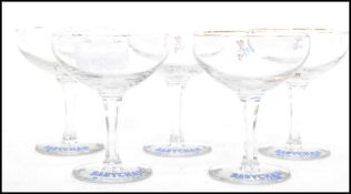 A group of five mid century retro advertising point of sale Babycham glasses having hexagonal