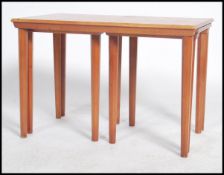 A 1970's retro Danish influence beech wood nest of tables each of graduating form being raised on