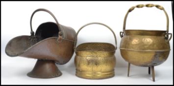 A group of copper and brass coal scuttles dating from the 19th century to include an example with
