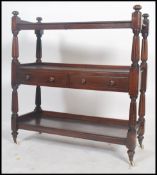 A 19th century mahogany 3 tier buffed / sideboard being raised on turned legs with white ceramic