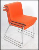 A group of three vibrant orange coloured padded cantilever Bulo tab chair by Alain Berteau, raised