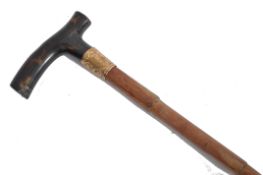 A 19th century Victorian walking stick cane having a tapering bamboo shaft with a shaped tortoise