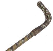 A 19th century Moroccan walking stick cane having a brass bound twist tapering shaft with inlaid