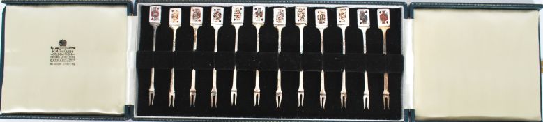 A fine cased silver hallmarked set of pickle forks by Garrard & Co of London. The set of 12 forks