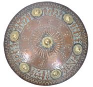 A believed 19th century copper and brass Islamic wall charger of armorial roundel form. The bowl