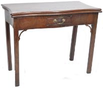 An 18th century Georgian solid mahogany fold over tea / games card table having a serpentine edge
