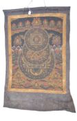 A 19th century Tibetan Thangka or Thanka being painted with a cross legged Buddha surround by his