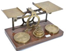 A large set of 19th century Victorian brass post office scales raised on a wooden plinth base with