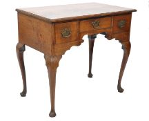 A 19th century oak lowboy desk being raised on splayed cabriole legs with three drawers, a short