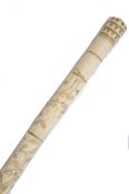 A 19th century Chinese bone walking stick cane. The tapering shaft of faux bamboo form decorated