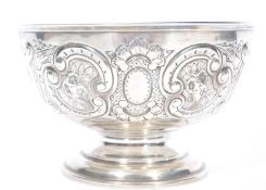 A large silver hallmarked fruit bowl with Bristol blue glass liner. The large bowl cast in relief