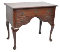 A 19th century oak lowboy raised on cabriole legs with pad feet having bat wing back plate drop