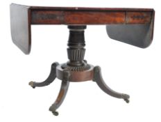 An early 19th century Georgian mahogany sofa table raised on a swept quadruped legs with ebony inlay