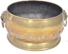 A 19th century Victorian brass jardiniere / coal bin having lion masks to sides with a gadrooned