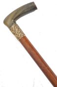 A 19th century Victorian walking stick cane having a tapered Malacca shaft with shaped horn