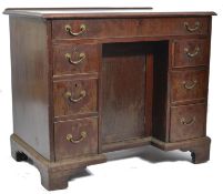 An 18th century Georgian  mahogany gents kneehole desk raised on bracket feet with central dog