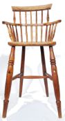 A 19th century country elm childs high chair. Raised on turned legs with h-stretcher having an elm