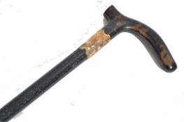 A 19th century Victorian walking stick cane having a tapering ebony shaft with shaped tortoise shell