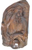 A 16th century Renaissance period limewood carving wall plaque mask carved in relief depicting a