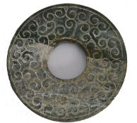 A Chinese Jade Bi having repeating scrolling motifs, Han style believed to date to the ming dynasty.