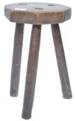 An early 19th century country elm milking stool. The wood of stunning rustic construction, hexagonal