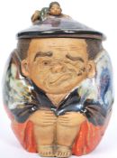 A charming 19th century sumida Japanese pottery jar in the form of   crouching and grimacing man.