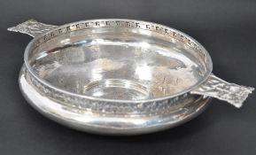 A silver hallmarked A. E. Jones silver Arts and Crafts twin handled bowl, of compressed form with
