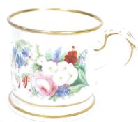 A 19th century Staffordshire commemorative mug / loving cup being decorated with a variation of
