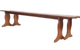 An exceptional pair of 19th century French fruit wood polished refectory pig benches. Each with