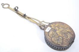 An early 19th century Georgian brass chestnut roaster of circular form depicting a Dutch Master