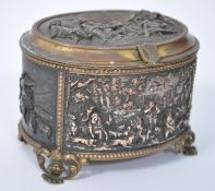 A 19th century French gilded ormolu copper jewellery casket of oval form. The top, front, sides