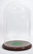 A large 20th century glass taxidermy / clock dome top cover with mahogany circular plinth stand.