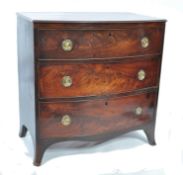 A 19th century Georgian flame mahogany bachelors bow front chest of drawers of small proportions.