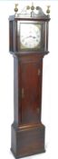 An 18th century oak and mahogany long case clock grandfather clock raised on a square pedestal