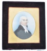 A 19th century portrait miniature painting on ivory plaque depicting a young parson - gentleman. .
